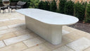 White concrete outdoor dining table on a stone patio, handcast by Curated Concrete